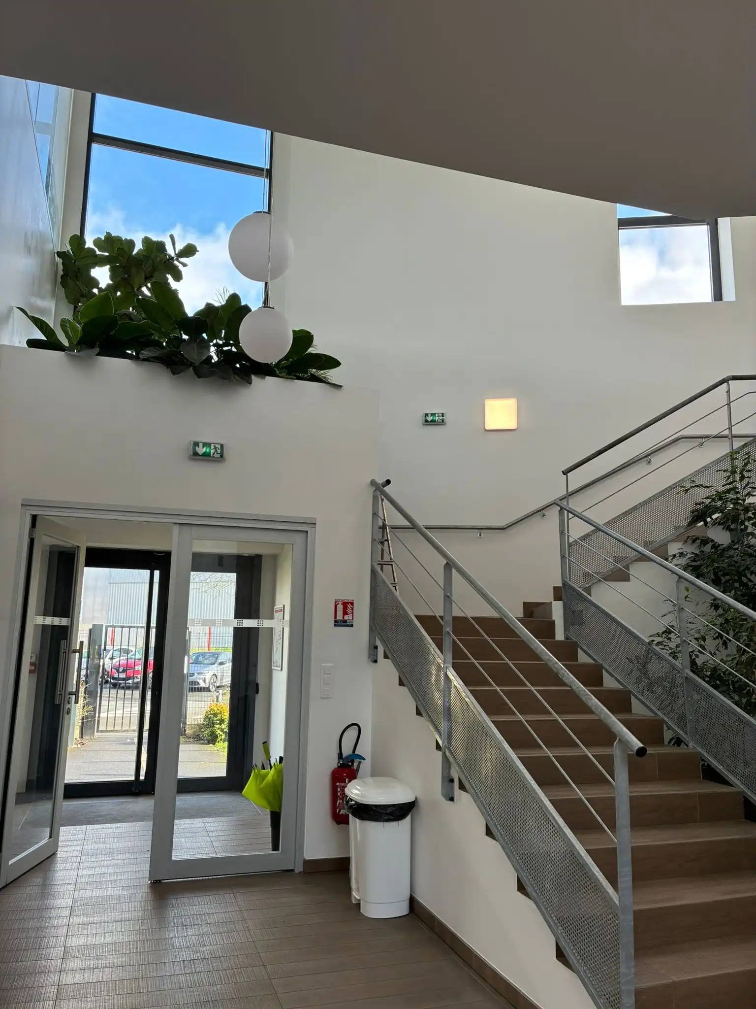 Entrée d'immeuble avec escalier végétalisé